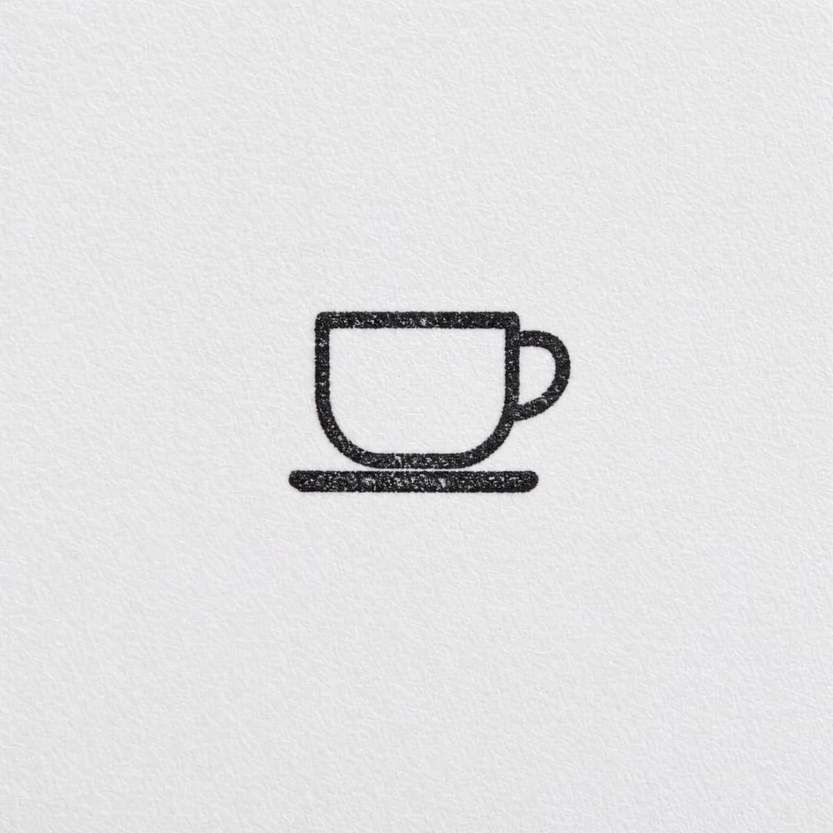 Petit logo de tasse sans cadre : exemple d’empreinte à l’encre noire sur papier blanc